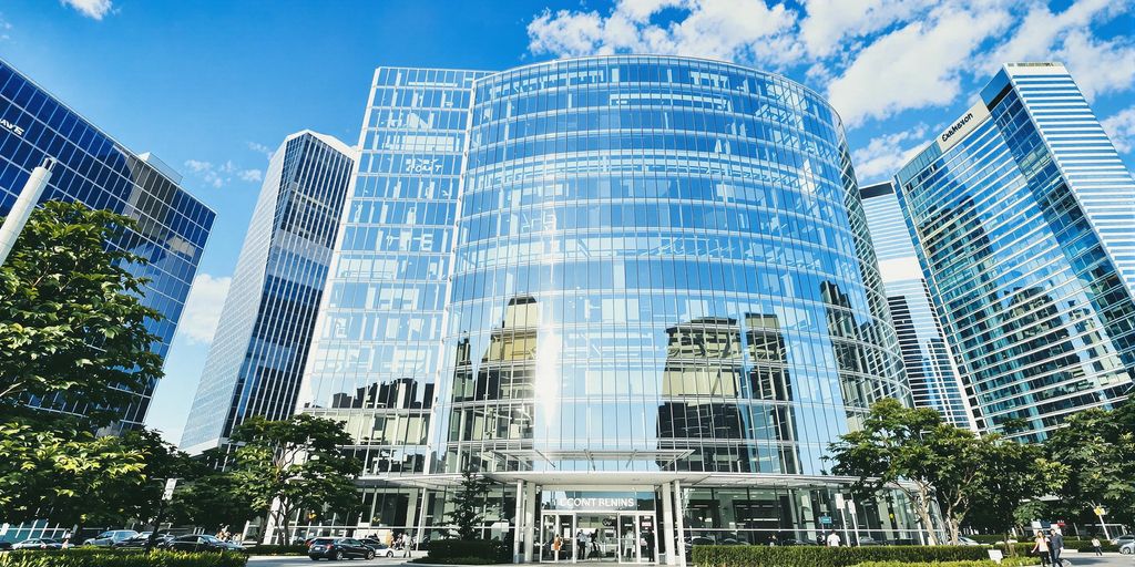 A sleek corporate building under a vibrant clear American sky.